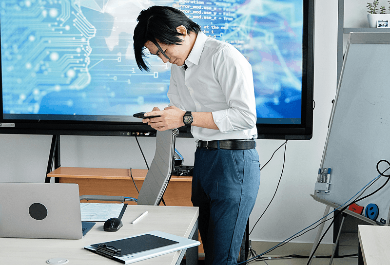Developer managing autonomous systems on desktop computer in office environment